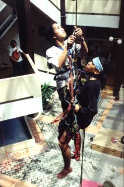 Students using rope climbing gear in the atrium. - jpg - 15592 Bytes